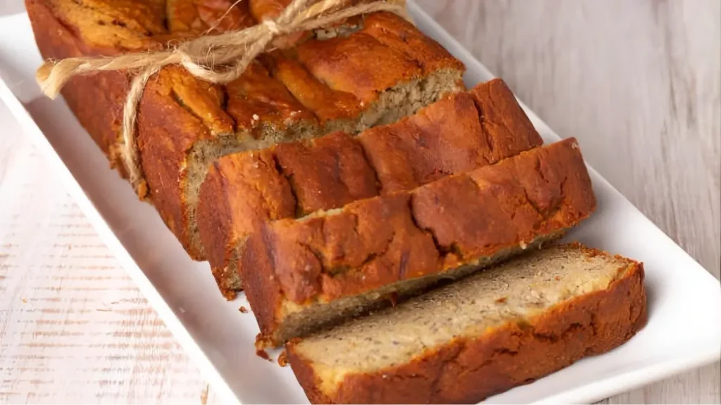 A collection of all the ingredients for honey sweetened almond flour banana bread, including almond flour, ripe bananas, eggs, coconut oil, honey, and cinnamon.