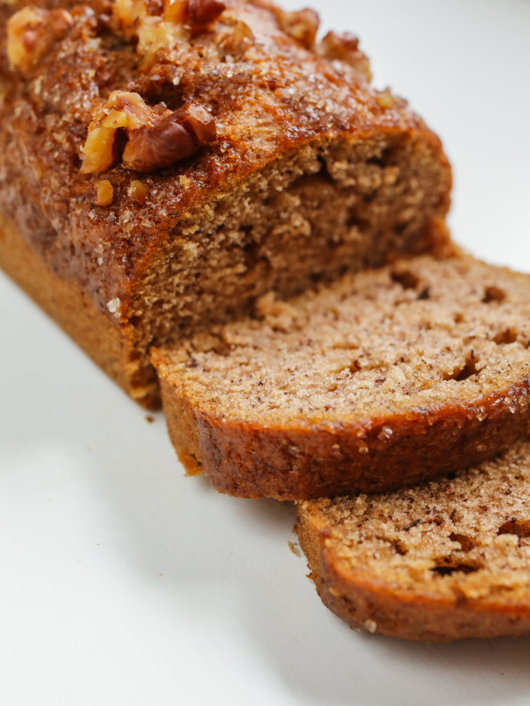 ​Sliced honey sweetened almond flour banana bread topped with chopped walnuts